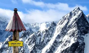 Słowacja góry: szczyt Łomnickie Sedlo (2190 m n.p.m.) w Tatrach Wysokich, pokryty śniegiem, z charakterystycznym drewnianym słupkiem i tabliczką.