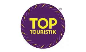 Logo "TOP TOURISTIK" w okręgu, symbolizujące najlepsze opinie turystów.