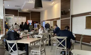 Ludzie jedzą w barze mlecznym, szukając dobrego jedzenia w Warszawie.