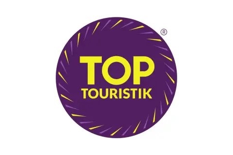 Logo "TOP TOURISTIK" w okręgu, symbolizujące najlepsze opinie turystów.