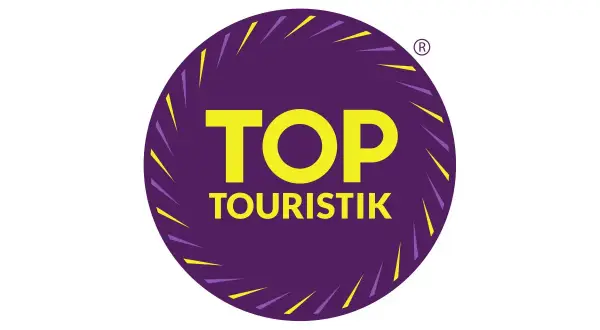 Logo "TOP TOURISTIK" w okręgu, symbolizujące najlepsze opinie turystów.