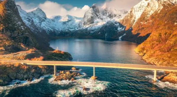 Mosty nad wodą, otoczone ośnieżonymi górami, idealne na fiordy norweskie wycieczka.