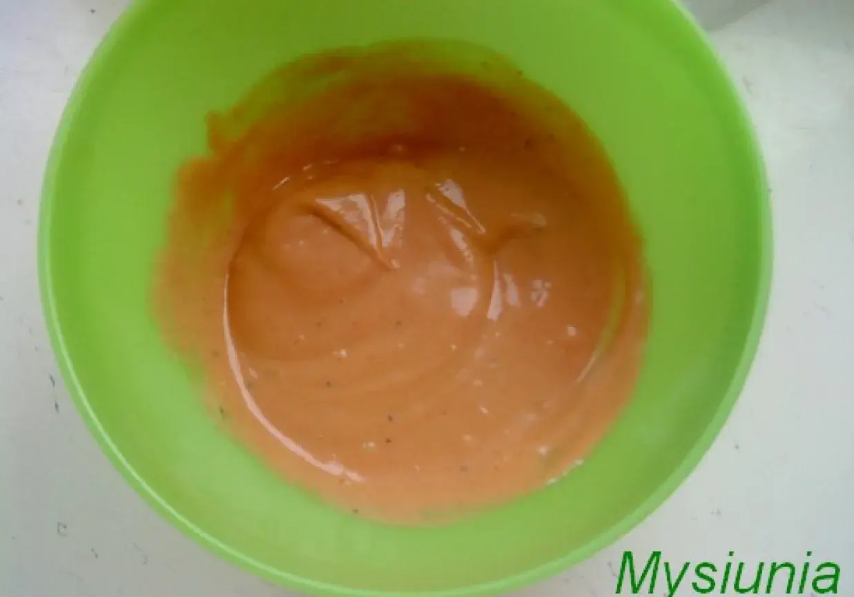 Pomarańczowy sos arabski w zielonej misce, gotowy do podania.