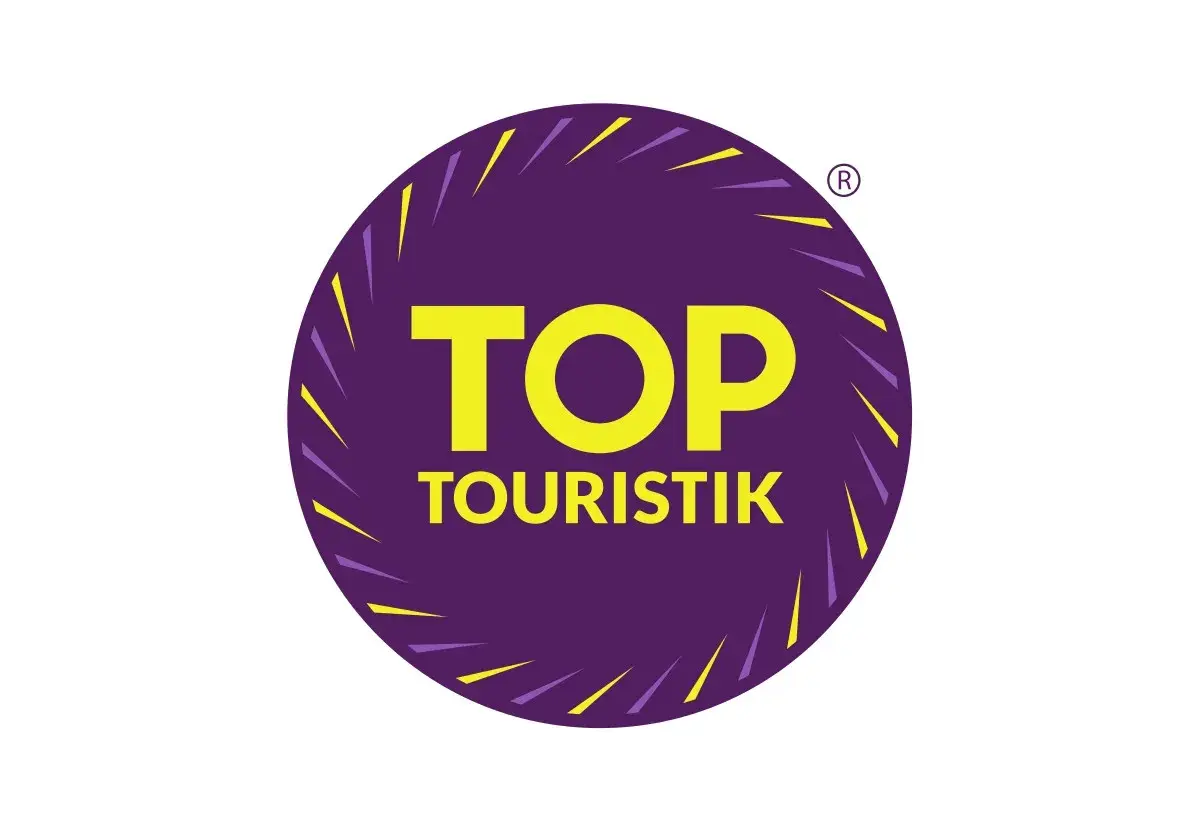 Logo "TOP TOURISTIK" w okręgu, symbolizujące najlepsze opinie turystów.