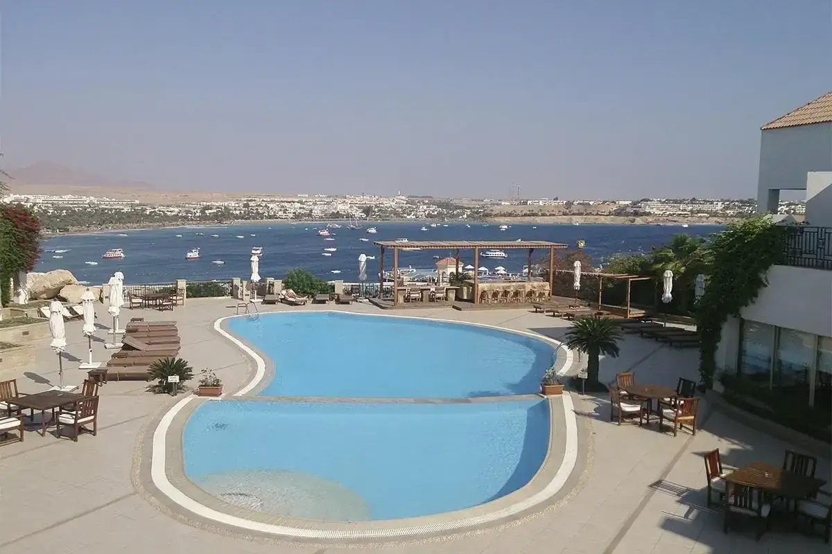 Idealna sharm el sheikh pogoda marzec: basen, morze z łodziami i słońce.