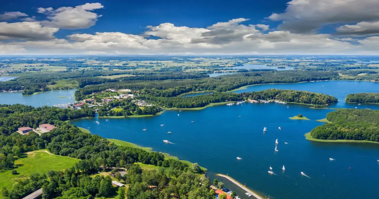 Malownicze jeziora i lasy, idealne miejsce, by odpocząć. Gdzie na Mazury? Tuż obok urokliwej miejscowości, pełnej żaglówek i zieleni.