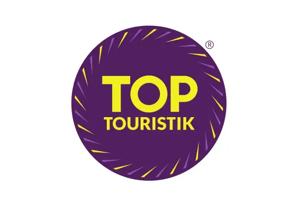 Logo "TOP TOURISTIK" w okręgu, symbolizujące najlepsze opinie turystów.