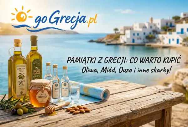 Oliwa, miód, ouzo – co przywieźć z Grecji? Pamiątki z wakacji na drewnianym stole z widokiem na grecką wyspę.